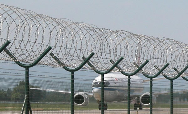 Concertina Wire Coils Above Welded Mesh Panels for High Security Perimeter Fencing